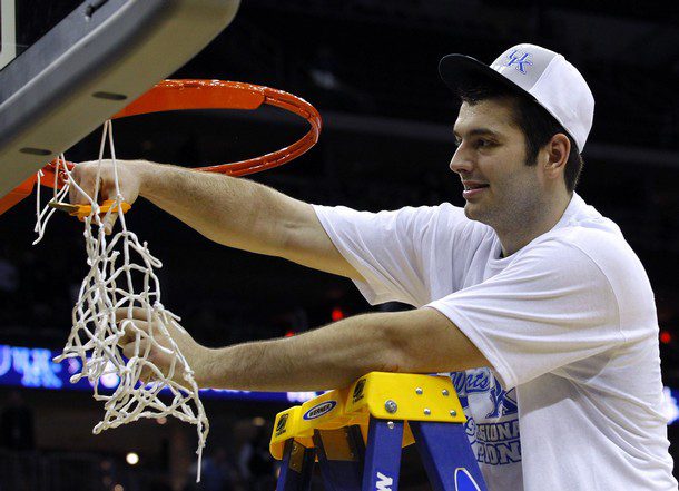 Wildcats' Harrellson clips the net after his team's victory over the Tar Heels in their NCAA East Regional game in Newark