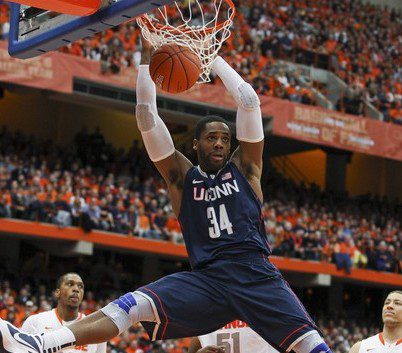 Connecticut Huskies forward/center Alex Oriakhi dunks the ball during the first half of their NCAA men's basketball game against Syracuse Orange in Syracuse, New York, February 11, 2012. REUTERS/Adam Fenster (UNITED STATES - Tags: SPORT BASKETBALL)