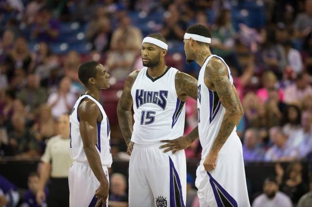 Kings guard Rajon Rondo, left, talks with center DeMarcus Cousins (15) and center Willie Cauley-Stein during their preseason game on Oct. 8 at Sleep Train Arena in Sacramento. Hector Amezcua
